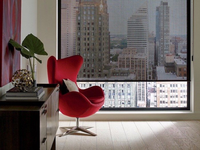 A living room with a red side chair.